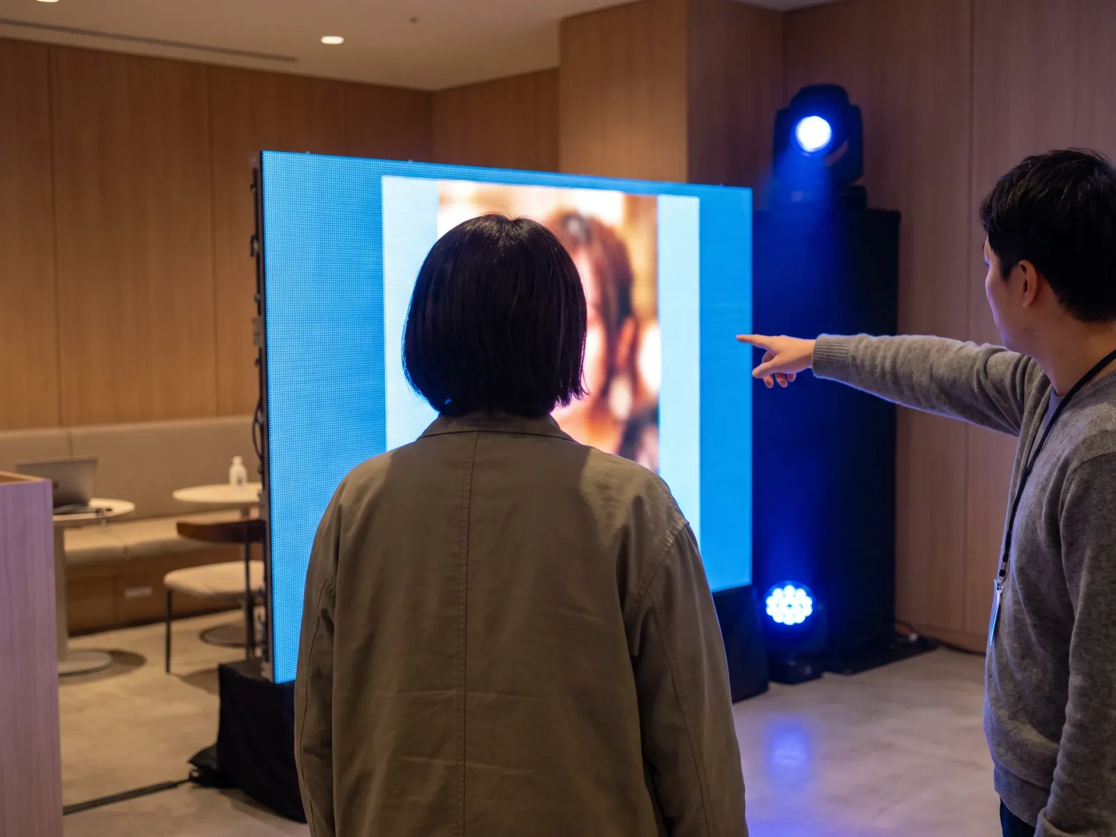 A screen showing a captured image being given a branded treatment, photographed over someone's shoulder