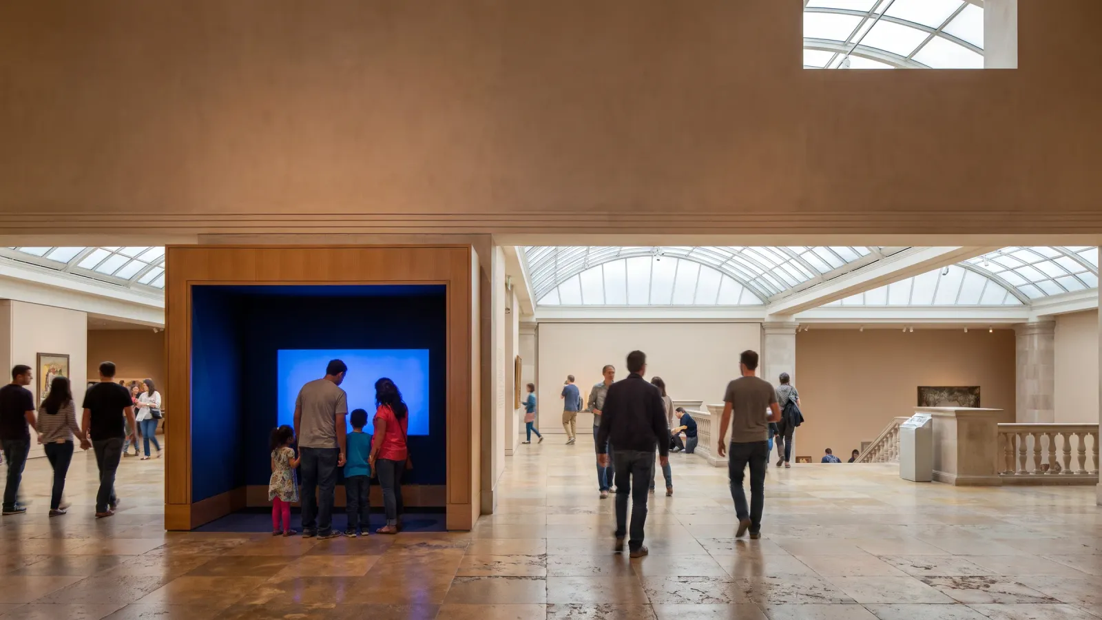 A permanent branded photo installation in a museum atrium with visitors passing by